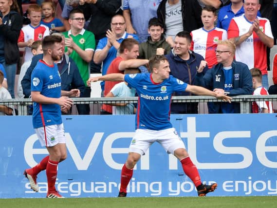 Joel Cooper (right) celebrates breaking the deadlock for Linfield against Crusaders.
