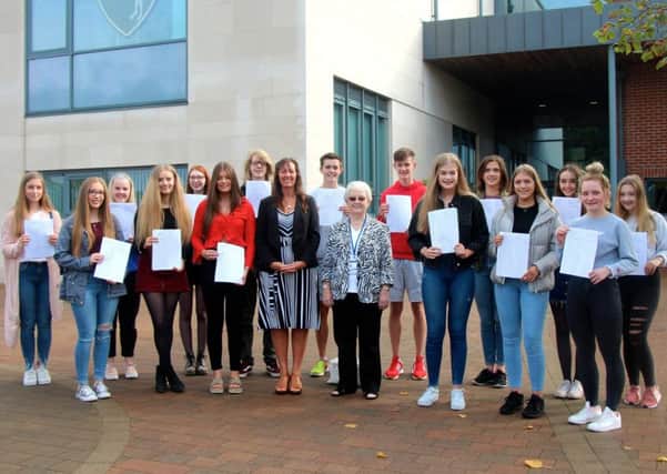 Grosvenor Grammar School GCSE students who achieved ten A* - A grades or better pictured with principal Dr Frances Vasey as well as the Education Authority's Miss Rosemary Rainey OBE.