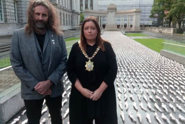 Artist Rob Heard and Lord Mayor Deirdre Hargey unveil the Shrouds of the Somme art installation in the Garden of Remembrance at Belfast City Hall.