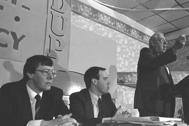 The Rev Ian Paisley flanked by Peter Robinson and Nigel Dodds during the DUP's annual conference at the La Mon House Hotel in 1990