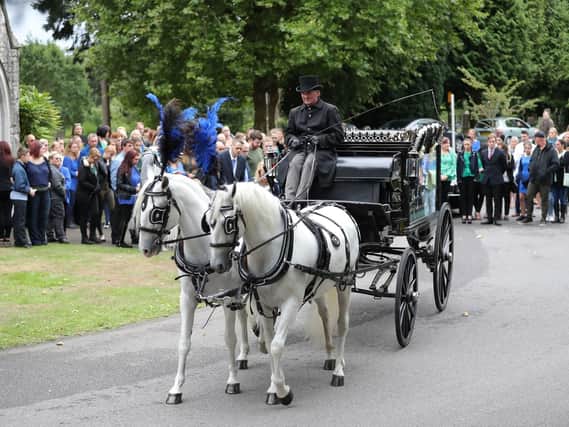 A horse-drawn hearse carrying the coffin of 13-year-old Lucy McHugh after her funeral ceremony at Hollybrook cemetery in Shirley, Southampton.