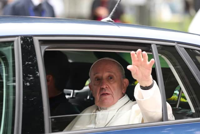 Pope Francis waves from inside one of the cars. (Photo: Maxwell's Photography)