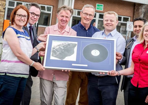 Billy Doherty (third from left) presents hospital staff with a framed Undertones LP as a thank you for the care he received