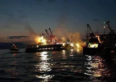 A large Scottish vessel is surrounded by smaller French fishing boats and attacked with flares