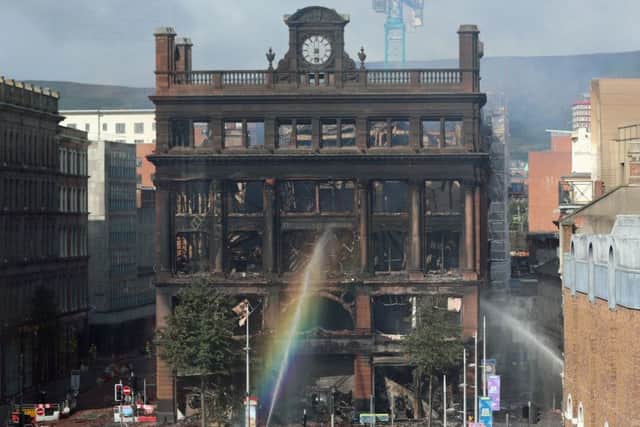 Still on Wednesday fire hoses spray water to dampen burning embers inside the Primark store in the historic five-storey Bank Buildings in Belfast city centre, where a major blaze broke out on Tuesday. Photo: Liam McBurney/PA Wire
