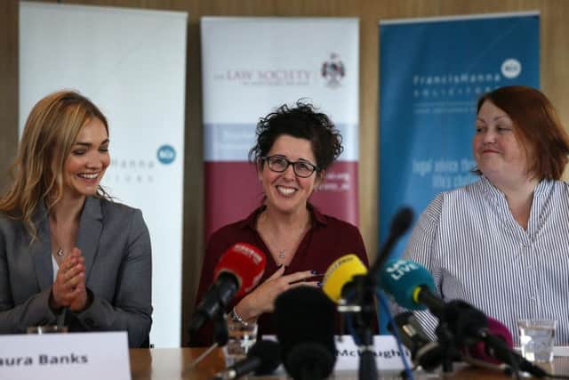 Unmarried mother Siobhan McLaughlin (centre) with her solicitor Laura Banks (left) and Denise Forde of Citizens Advice at a press conference at Law Society House, Belfast