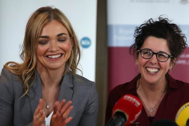 Unmarried mother Siobhan McLaughlin (right) is greeted by her solicitor Laura Banks on her arrival for a press conference at Law Society House, Belfast, following the Supreme Court ruling in her favour, after she was refused a number of benefits following her partners death because they were not married or in a civil partnership