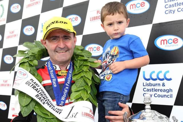 Paul Robinson with his son Max after he won the Ultra-Lightweight races at the Ulster Grand Prix in 2017.