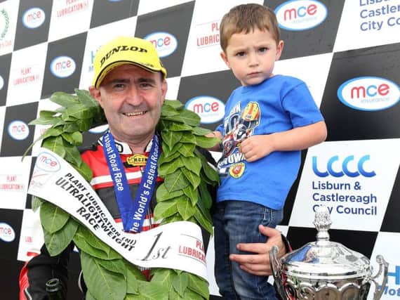 Paul Robinson with his son Max after he won the Ultra-Lightweight races at the Ulster Grand Prix in 2017.