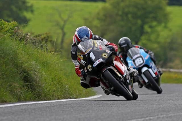 Ballymoney man Paul Robinson leads Christian Elkin at the Ulster Grand Prix last year in the 125/Moto3 class.