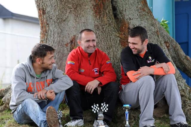 Paul Robinson with his cousins Sam (left) and William Dunlop at Walderstown in 2012.