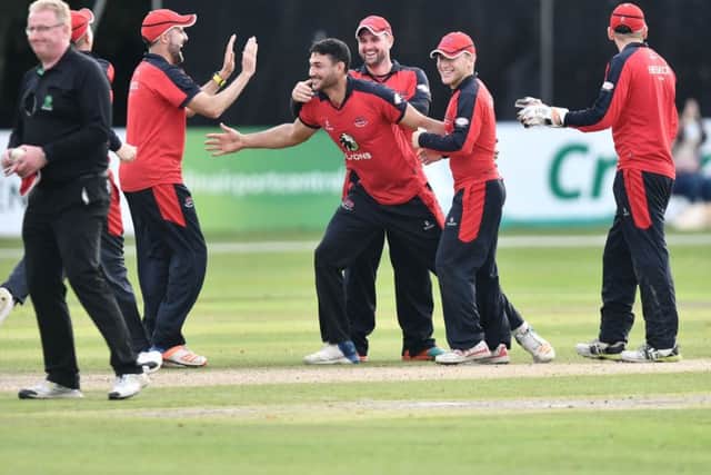 Shaheen Khan, centre, celebrates taking the final wicket as Waringstown clinched an 85-run win