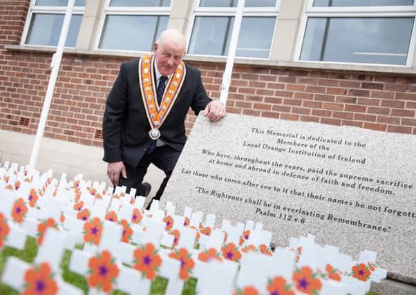 Grand Master of the Grand Orange Lodge of Ireland, Edward Stevenson, pays his respects at the Institution's memorial garden on Orange Victims' Day