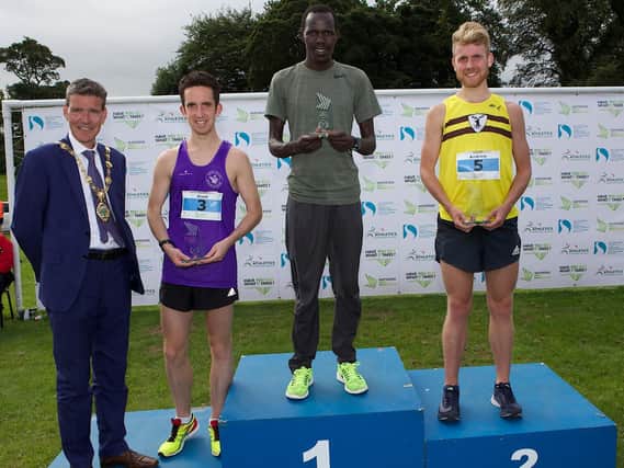 Kenyan FreddieSittuk takes top spot on the podium at the Waterside Half Marathon fro North Belfast Harriers' AndrewAnnett in second and Foyle Valley's Scott Rankin in third.
