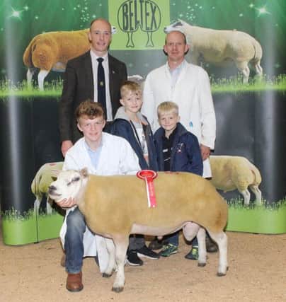 Winning smiles: Andrew, Jamie, Dale and Jaden McCutcheon, Bodoney Beltex with their Supreme Champion, Lot 38, Bodoney Caveman ET, a Shearling Ram and judge, Grant Anderson.