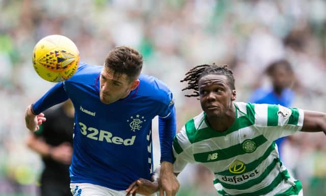 Celtic's Dedryck Boyata (right) and Rangers Kyle Lafferty battle for the ball