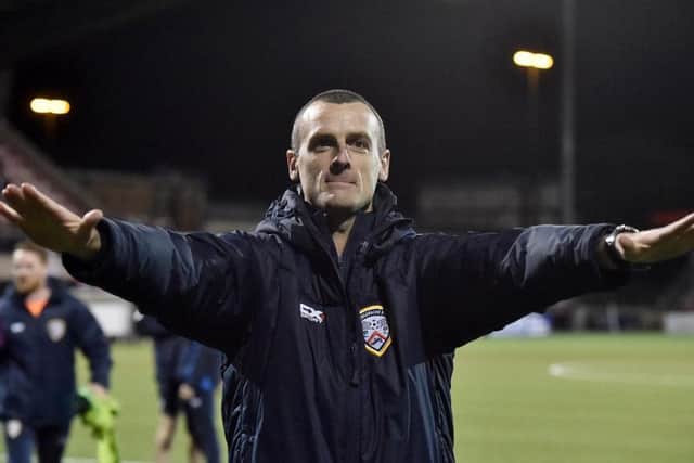 Oran Kearney salutes the Coleraine fans after the game.