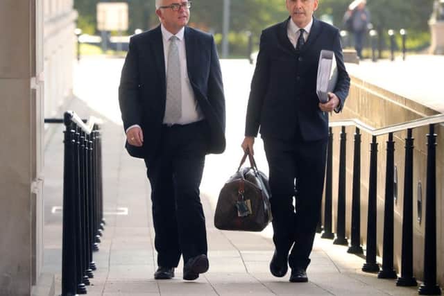 Former DUP minister Jonathan Bell (left) and his solicitor Denis Moloney arrive at the RHI inquiry at Stormont Parliament buildings in Belfast.
