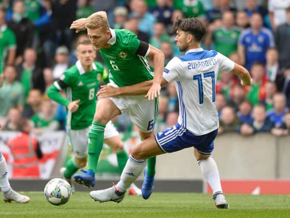 Northern Ireland's George Saville looks to be brought down by Bosnia defender Ervin Zukanovic.