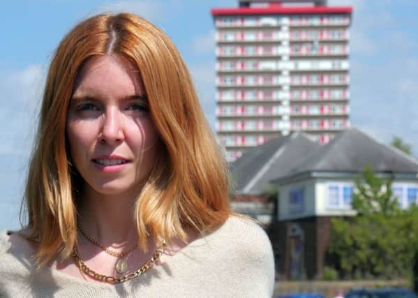 Stacey Dooley pictured in Belfast with Divis Tower in the background background. Stacey Dooley - (C) BBC - Photographer: Joseph McAuley