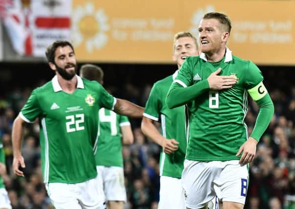 Northern Ireland skipper Steven Davis wheels away in celebration after he opened the scoring in Tuesday night's 3-0 win over Israel at Windsor Park.