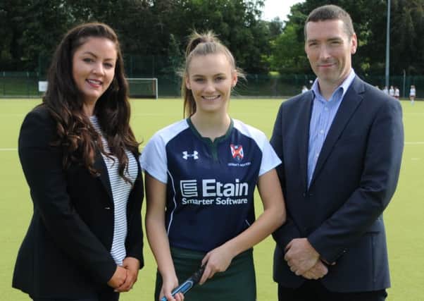 Hilary McEwan and Martin Goss (Etain) pictured with Queen's and Ireland player Jessica McMaster.
