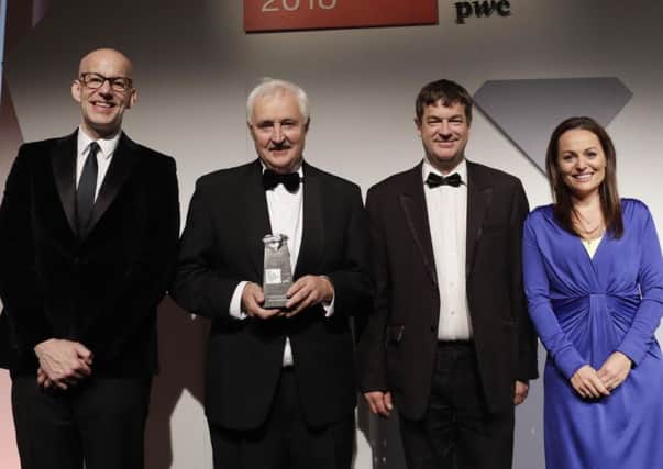 Bryson CEO John McMullan pictured with the Bryson award with, from left, PwC partner Brian Henderson, Goodwill Solutions director of finance Damian Pickard and presenter Victoria Fritz