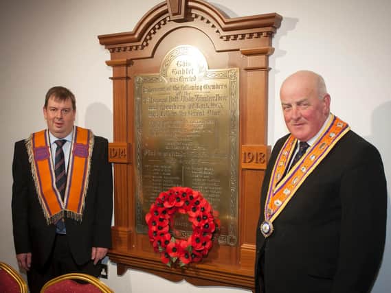 Deputy Master LOL 1063, Stewart McClean and Grand Master of the Grand Orange Lodge of Ireland Edward Stevenson (right), with the restored WW1 memorial tablet after it was destroyed in an arson attack in 2014 in Newtown Cunningham Orange Hall.