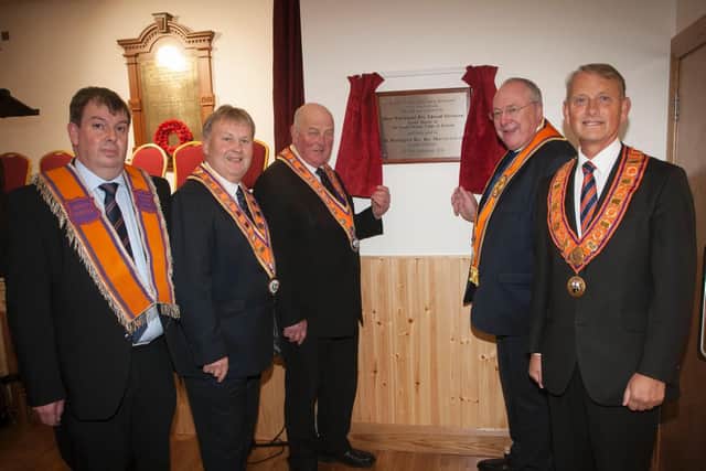 Grand Master of the Grand Orange Lodge of Ireland Edward Stevenson (third left) unveils a plaque marking the official opening of Newtown Cunningham Orange Hall, as (left to right) Deputy Master LOL 1063 Stewart McClean, Deputy Grand Master Harold Henning, Grand Secretary Rev. Mervyn Gibson and City of Londonderry Grand Master Maurice Devenney look on