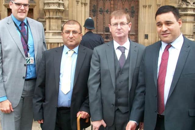 Ishan Bashir, centre, with walking stick at Westminster. His brother Inam was killed in the 1996 IRA Canary Wharf bomb. Also with him is Jonathan Ganesh, right, who was injured in the bomb and, left, Gavin Robinson MP and the victims' campaigner, Willie Frazer, second from right