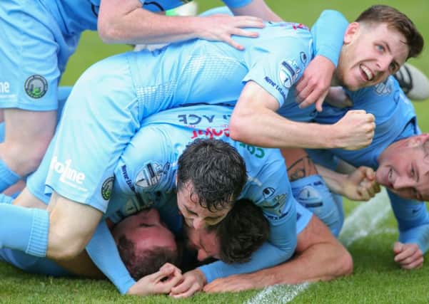 Warrenpoint Town players celebrate their win over Cliftonville last weekend
