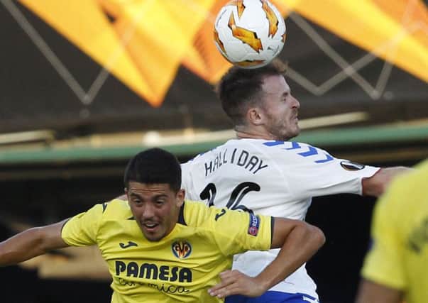 Rangers Andrew Halliday  jumps for the ball above Villarreal Pablo Fornals last night