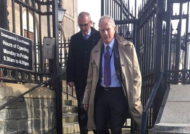 NIW director Sean McAleese (left) and solicitor John Burke leave Downpatrick Crown Court after the verdict