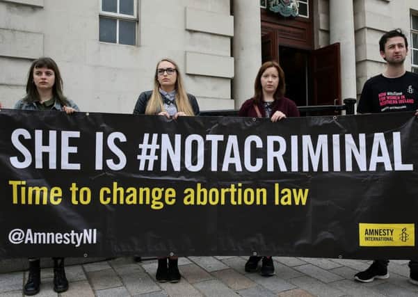 Pro choice advocates outside the High Court in Belfast where the court is to hear a judicial review taken by a mother who was prosecuted for securing abortion pills for her daughter. PRESS ASSOCIATION Photo