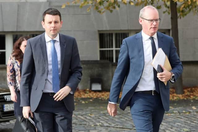 Irish Minister for Foreign Affairs Simon Coveney (right) and his Press Advisor Chris Donoghue