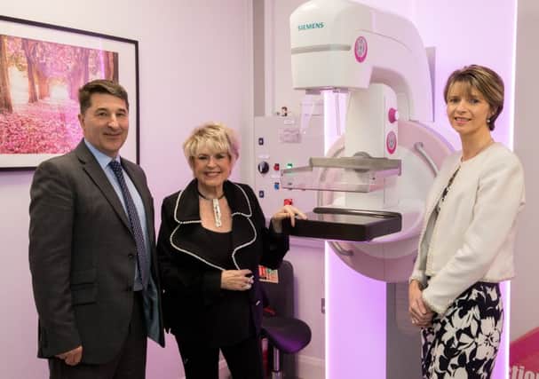 Gareth Kirk (Action Cancer Chief Executive), Gloria Hunniford OBE (Action Cancer Patron) and Ashley Hurst (Action Cancer Ambassador) pictured in front of the 3D breast screening machine in Action Cancer's Screening Centre