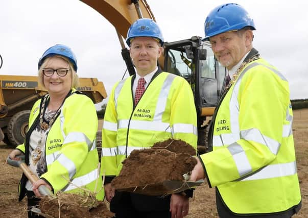 Causeway Coast and Glens Mayor Brenda Chivers, Northern Divisional Roads Manager David Porter and Derry City and Strabane Deputy Mayor Derek Hussey cut the first sod on construction of the A6 Dungiven to Drumahoe road upgrade