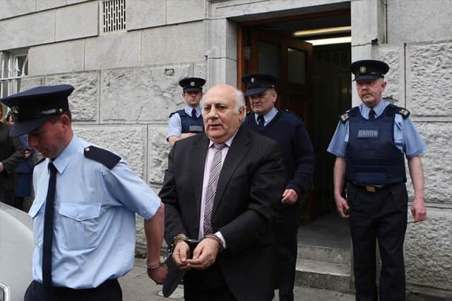 Ted Cunningham who laundered cash from the Northern Bank robbery being led away after receiving a ten years jail sentence in 2009. The 60-year-old, from Farran in Co Cork, was also found guilty at Cork Circuit Criminal Court in the Irish Republic of nine counts linked to a dirty money racket which moved cash from Belfast to Cork. Photo: Julien Behal/PA Wire