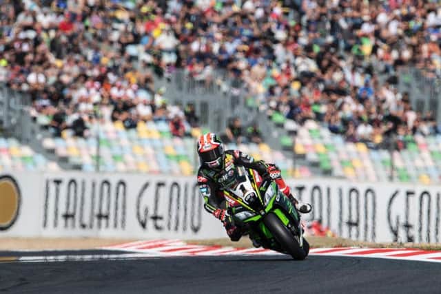 Kawasaki rider Jonathan Rea won Saturday's opening race at Magny-Cours in France by three seconds from team-mate Tom Sykes to secure a fourth successive World Superbike crown.