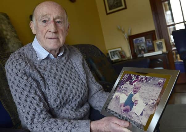 Jackie Nicholl at his home holding a picture of his son Colin. Picture by Arthur Allison/Pacemaker