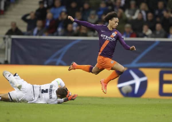 Manchester City midfielder Leroy Sane jumps over Hoffenheim goalkeeper Oliver Baumann