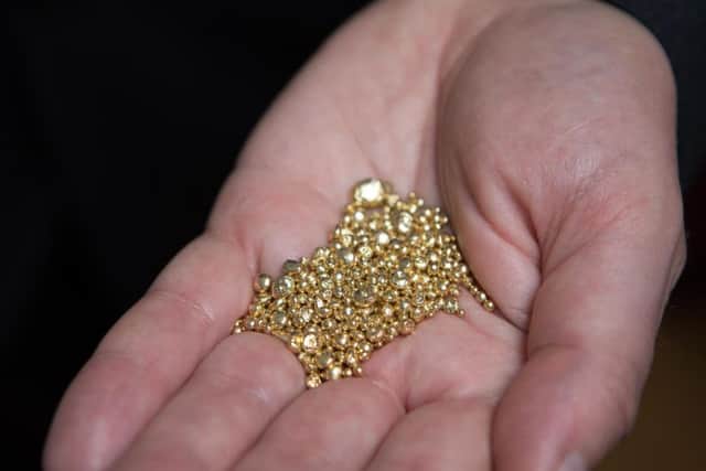 File photo dated 21/09/17 of grains of gold. No decision can be made on planning permission for a Co Tyrone gold mine until a minister is available, a Stormont department has said.