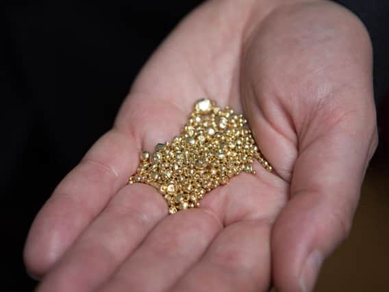 File photo dated 21/09/17 of grains of gold. No decision can be made on planning permission for a Co Tyrone gold mine until a minister is available, a Stormont department has said.