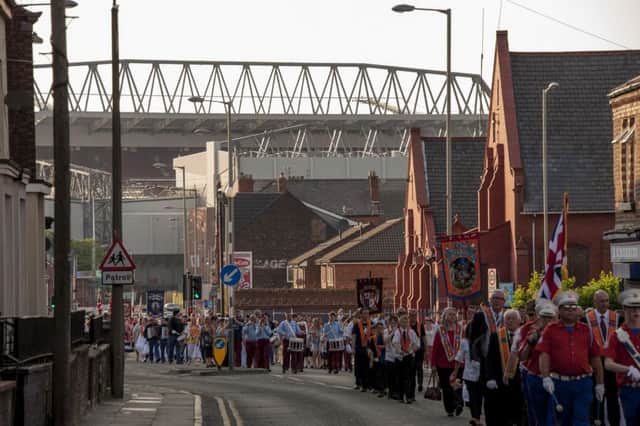 An Orange parade taking place through the streets of Anfield, Liverpool