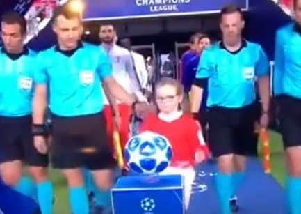Grace prepares to lift the match ball as she leads out the players and officials for Wednesday night's Champions League game between Tottenham and Barcelona