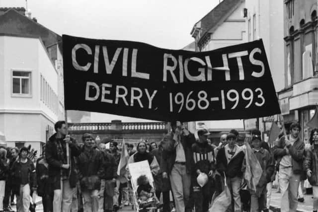Demonstrators make their way across Ferryquay Street in Londonderry on the 25th anniversary of the October 5, 1968, Civil Rights march in 1993