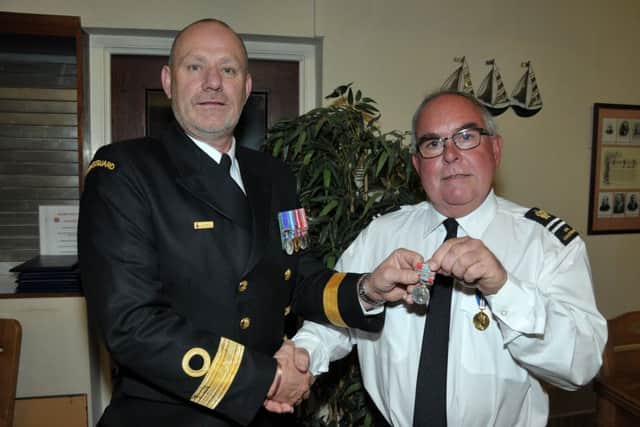 Clifford Kerr, Station Officer at Portmuck Coastguard Search and Rescue Team, receives his long service medal from Pete Mizen, Head of HM Coastguard Coastal Operations. Clifford has served 40-plus years with HM Coastguard. INLT 39-201-AM