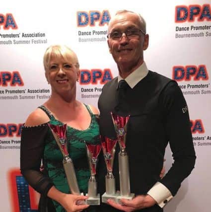 Angela and John with some of the trophies