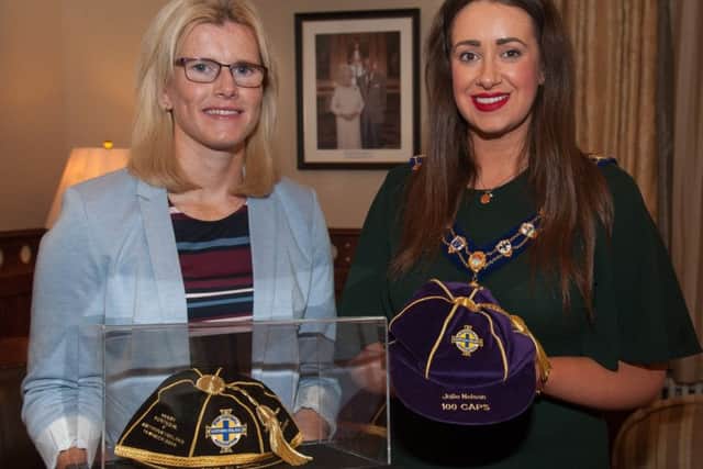 Julie Nelson displays some of her caps to mayor Cllr. Lindsay Millar.