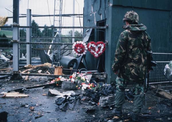 A soldier examines the scene at the Coshquin checkpoint where human bomb Patsy Gillespie and five soldiers were killed in October 1990